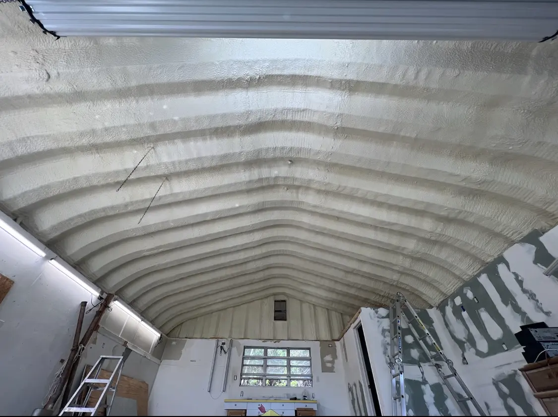 Spray polyurethane foam applied to the underside of a metal roof deck in Bonham